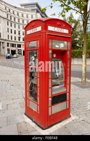 old red telephone box converted into a phone box and atm cash machine Birmingham UK Stock Photo