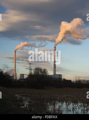 big power plant at sunset with two stacks Stock Photo