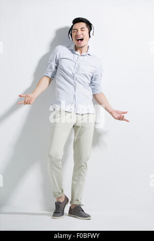 Happy young man listening to music Stock Photo