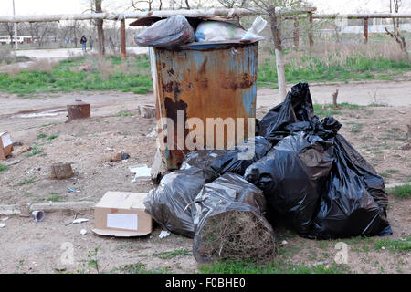 pile black garbage bag plastic and four dustbin dirty roadside in the city  with copy space add text Stock Photo - Alamy
