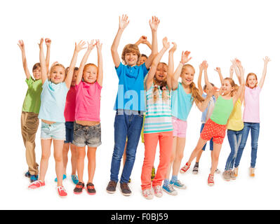 Group of happy kids with raised hands on white Stock Photo