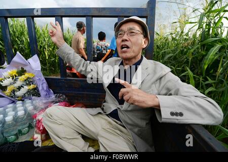 Mudanjiang City, China. 11th Aug, 2015. 73-year-old Japanese Yohachi Nakajima, a 'war orphan' left in China after WWII, takes a truck to find the tomb of his adoptive parents in Mudanjiang City, northeast China's Heilongjiang Province, Aug. 10, 2015. Nakajima went to northeast China's Heilongjiang province in 1942 with his family as members of 'the Japanese settlers group' when he was only a one-year-old baby. But in 1945, when the militaristic Japan surrendered at the end of World War II, he was left in China solely. Credit:  Xinhua/Alamy Live News Stock Photo