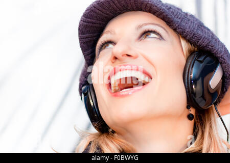 Blonde lady listening to the music. Stock Photo