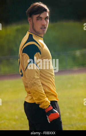 Confident soccer player looking away while standing on field Stock Photo