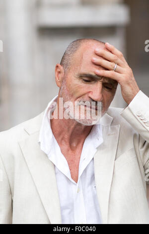 Elderly man having headache outside Stock Photo