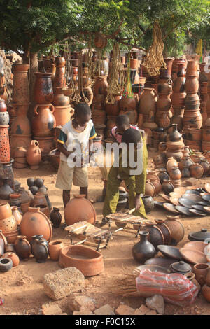 BANDIAGARA, MALI - OCTOBER 5, 2008:  Unidentified children in a pottery shop in bandiagara in the Mopti region in Mali on octobe Stock Photo
