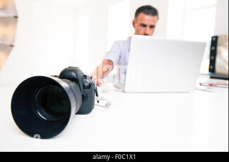 Closeup portrait of a young man using laptop. Focus on camera Stock Photo