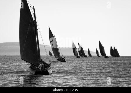 Traditional wooden boats Galway Hooker, with red sail, compete in regatta. Ireland. Stock Photo