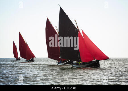 Traditional wooden boats Galway Hooker, with red sail, compete in regatta. Ireland. Stock Photo