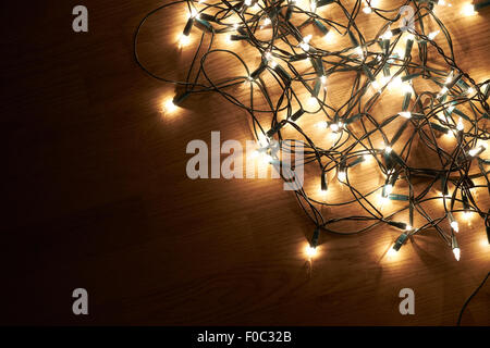 Traditional Christmas Tree lights lying on a wooden floor. Stock Photo