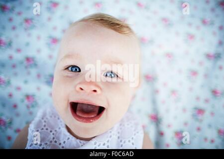 Portrait of smiling baby girl laying on mat Stock Photo