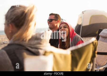Group of friends camping on beach Stock Photo