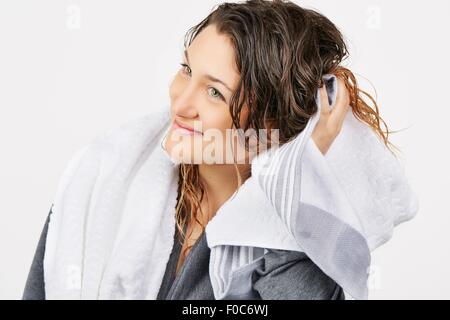 Young woman towel drying hair Stock Photo