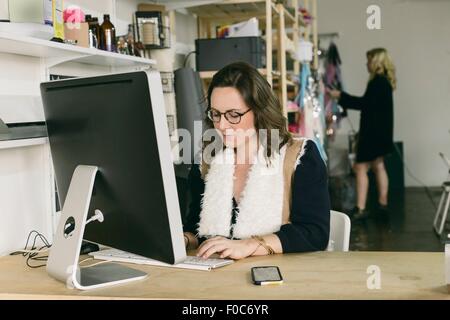Female office worker at desk in design studio Stock Photo