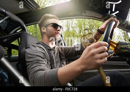 Portrait of man driving wearing sunglasses Stock Photo
