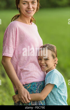 Portrait of two smiling girls hugging in stadium stand Stock Photo - Alamy