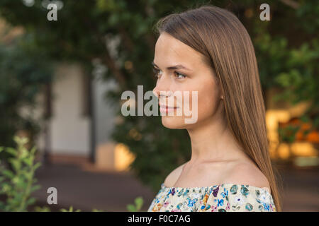 Side view of beautiful young woman looking away outdoors Stock Photo