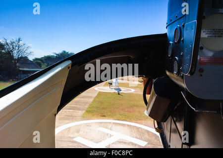Helicopter landing from cabin. Helipad visible through glass. Stock Photo
