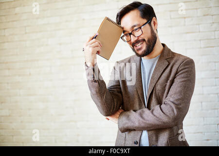 Happy businessman with notepad Stock Photo