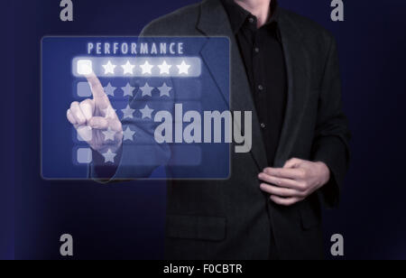 Businessman pressing performance on virtual screen Stock Photo
