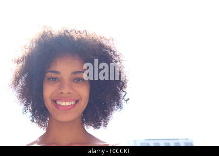 Happy black woman outdoors with lens flare in her afro Stock Photo