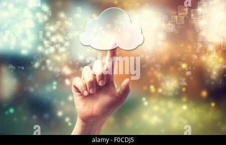 Cloud computing symbol being pressed by a persons hand Stock Photo