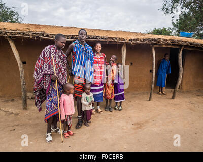 Maasai family wearing traditional everyday clothes in their boma (village) in Tanzania, Africa. Stock Photo