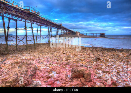 Birnbeck victorian Pier Weston-super-Mare Somerset England in colourful HDR like painting with red rocks in foreground Stock Photo