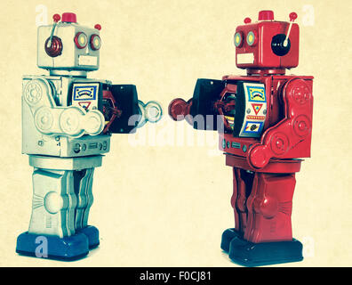 two robots looking at each other Stock Photo