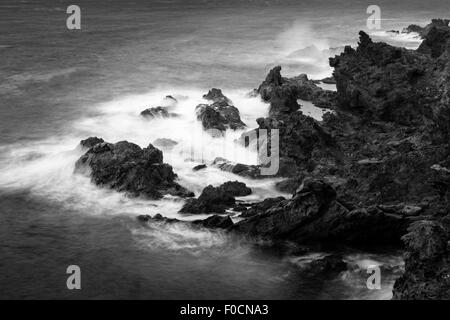 Long exposure view of the atlantic ocean on the rugged rocky coastline of Tenerife, Canary Islands, Spain. Color F0CNA6