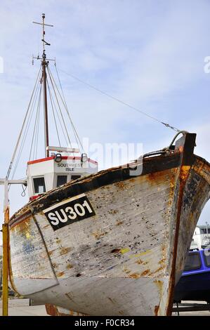 Fishing boat on quayside of the harbour at West Bay, Dorset, England Stock Photo