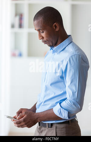 Portrait of a young African American business man using a mobile phone - Black people Stock Photo