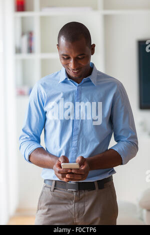 Portrait of a young African American business man using a mobile phone - Black people Stock Photo