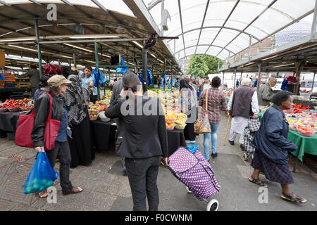 multi cultural multi ethnic shoppers at outdoor fruit market Birmingham UK Stock Photo