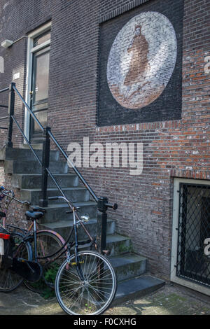 Typical Amsterdam street scene of street art graffiti and parked ...