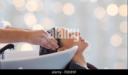 happy young woman having salon hair wash Stock Photo