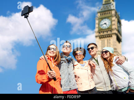 smiling friends taking selfie with smartphone Stock Photo