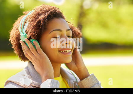 african woman in headphones listening to music Stock Photo