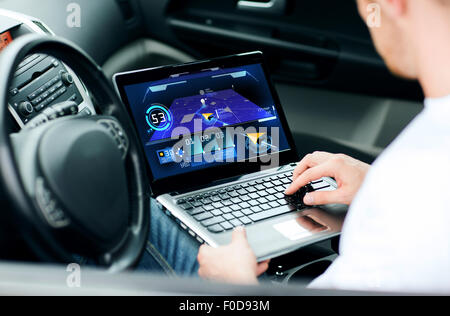 man using navigation on laptop computer in car Stock Photo