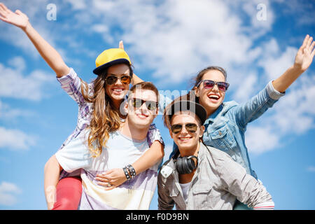 smiling teenagers in sunglasses having fun outside Stock Photo