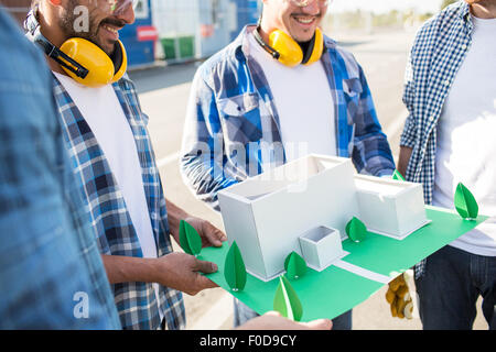 close up of builders with paper house model Stock Photo