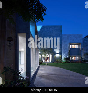 Front and facade elevation with garden at dusk. Marbled House, Ahmedabad, India. Architect: Matharoo Associates, 2015. Stock Photo