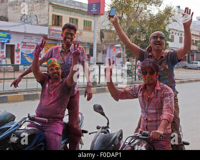 Revelers in Udaipur celebrating the annual Hindu festival of colors known as Holi. It is also known as the festival of Love Stock Photo