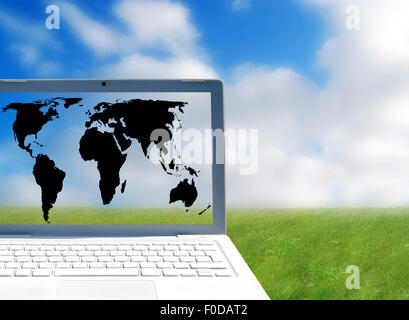 World ouline map on laptop screen over outdoor scene Stock Photo