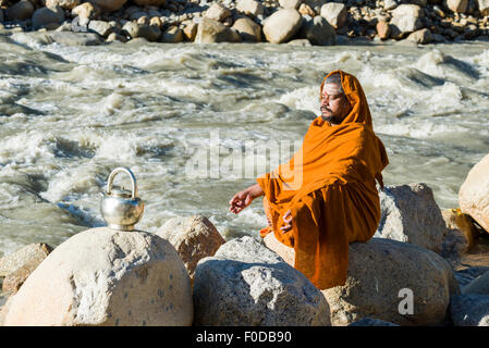 A Sadhu, holy man, is sitting and meditating in lotus pose, padmasana ...