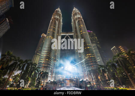 Fountain in front of the illuminated Petronas Tower at night, Kuala Lumpur, Malaysia Stock Photo