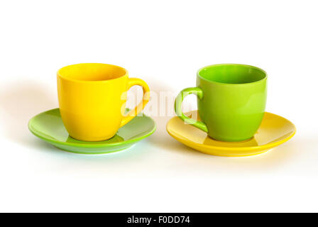 Two colored tea cups and saucers on white background. Stock Photo