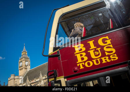 Tourists on the top deck of a sightseeing bus in London. Stock Photo
