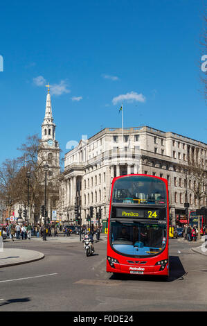 Double decker bus driving past Trafalgar Square in the City of London, England. Stock Photo