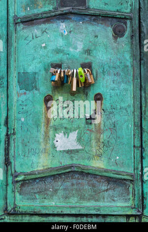 London Southbank Westminster Bridge metal copper cabinet door detail tourist graffiti padlock padlocks on handle Stock Photo